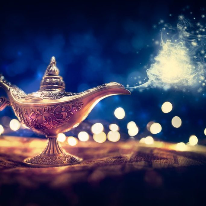 Magic lamp from the story of Aladdin with Genie appearing in blue smoke concept for wishing, luck and magic
